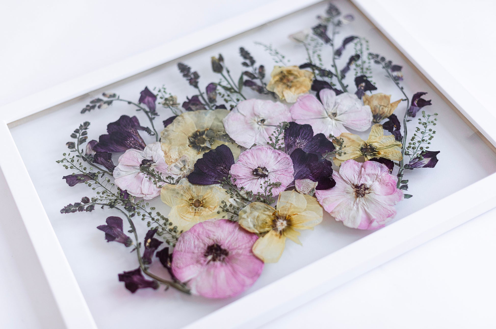 wedding bouquet preserved in a white modern frame 